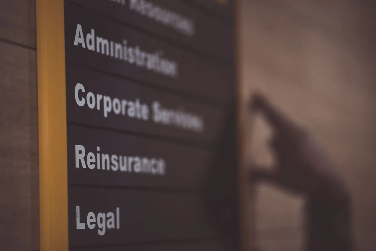 Office signage Austin directory board listing Administration, Corporate Services, and Legal departments